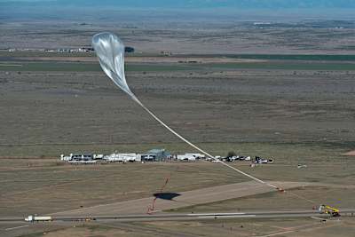 The crane follows the balloon with the capsule at the flight line during the final manned flight for Red Bull Stratos in Roswell, New Mexico, USA on October 14, 2012.