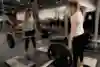 Lifting the barbell to knee height during a deadlift.
