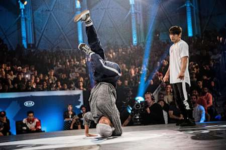 Ayumi does an elbow freeze with Kill in the background.