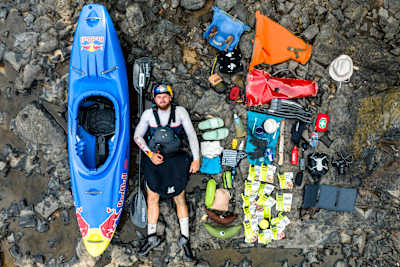Kayaker Adrian Mattern pictured with his kayak and all his expedition equipment in Gabon.