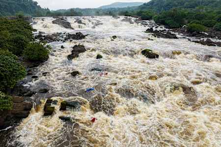 Kayakers negotiate white water on the Ivindo River, Gabon.