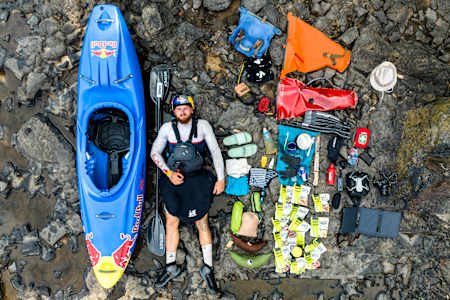 Kayaker Adrian Mattern pictured with his kayak and all his expedition equipment in Gabon.