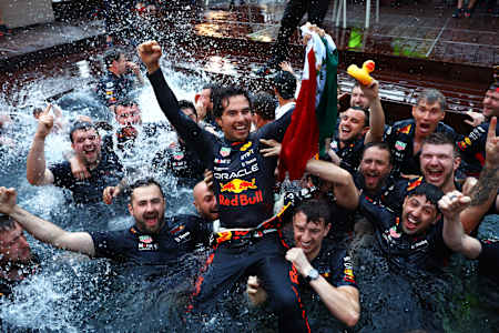 Race winner Sergio Perez celebrates with his team by jumping into the pool after the F1 Grand Prix of Monaco at Circuit de Monaco on May 29, 2022 in Monte-Carlo, Monaco. 