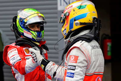 An image of Felipe Massa and Lewis Hamilton shaking hands at the 2008 Grand Prix of Belgium at Circuit de Spa-Francorchamps.