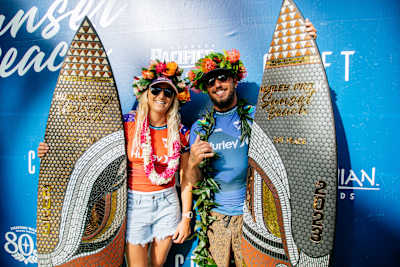 Molly Picklum and Filipe Toledo on the Hurley Pro Sunset Beach podium in Hawaii on February 19, 2023. 
