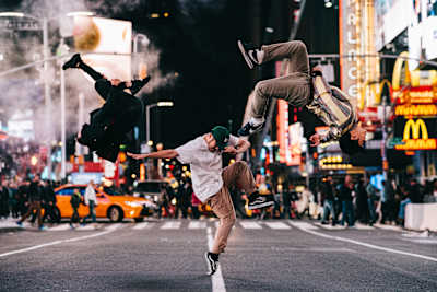 Dancers Abel, Wingzero and Issei captured in an action shot on New York's Times Square by photographer Little Shao.