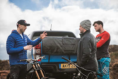 Gee Atherton in deep conversation with Matt Jones and Jono Jones during a visit by the brothers to DYFI Bike Park in Wales.