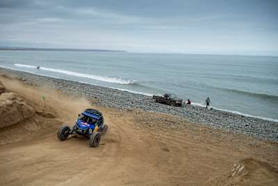 A buggy driver drives his buggy on the Pacific coast of Baja Mexico.