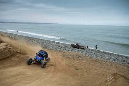 A buggy driver drives his buggy on the Pacific coast of Baja Mexico.