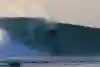 Surfer Eddie Blackwell performs a turn on a heavy wave in Indonesia.