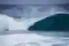 Surfer Jack Robinson rides the tube at Pipeline in Hawaii