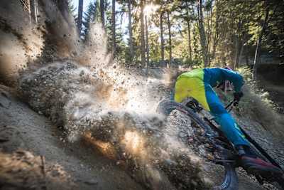 Kicking up some dirt A rider locks up on a turn on a DH MTB Course in the UK.