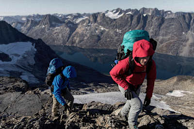 Hikers climb a mountain wearing Arc’teryx Bora AR 50 Backpack.