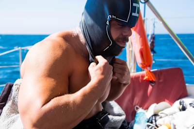 Ross Edgley pulls wetsuit hood over his head as he prepares for a leg of his Great British Swim challenge to swim around the entire UK in 100 days.