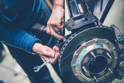 A close-up photo of the disc brake on a Peugeot 3008DKR Maxi rally raid vehicle taken at the PSA factory in Versailles, France, in 2017.