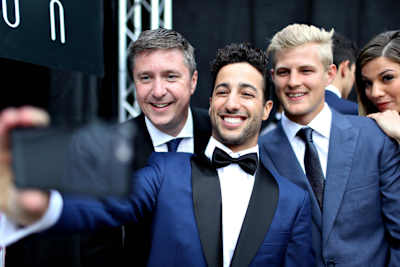 A photo of Daniel Ricciardo taking a selfie photograph of himself, F1 commentator David Croft and Marcus Ericsson.
