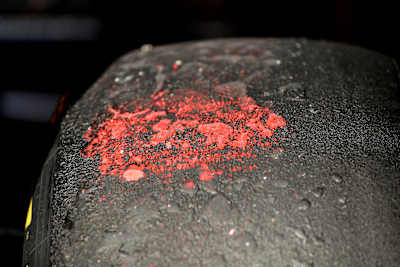 A Worn Medium Tyre With Paint From The Curbs