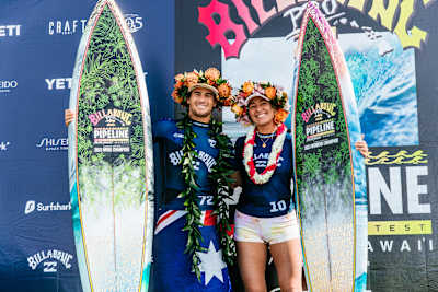 Jack Robinson and Carissa Moore on stage after winning the 2023 Billabong Pro Pipeline event in Hawaii. 