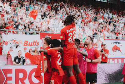 Red Bull Salzburg players celebrate with the team's fans in the Red Bull Arena.