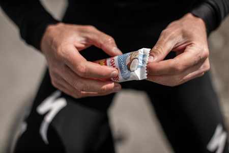 Anton Palzer unwraps a chocolate bar after finishing a winter training ride.