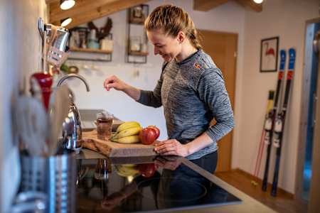 Telemark skier Johanna Holzmann prepares her breakfast and a fruit tea at home.