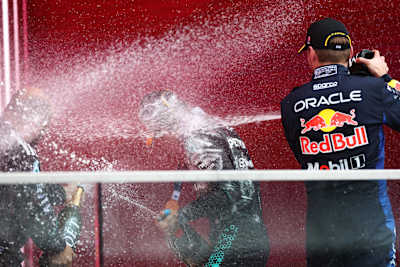 Kimi Antonelli and Max Verstappen celebrate on the podium with champagne after the F1 Grand Prix of Canada in May 2026. 