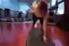 Head on view of a plank with dumbells, showing how close the lifting arm should be to the body.