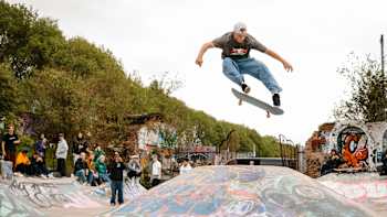 Jake Wooten skateboarding in front of a crowd at the Arches DIY Skatepark in Glasgow, Scotland on May 17, 2022.