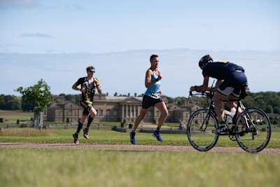 Participants race against the backdrop of the 18th century Holkham Hall