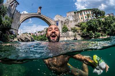 Catalin Preda of Romania reacts after diving from the 27m platform on Stari Most at the Red Bull Cliff Diving World Series in Mostar, Bosnia and Herzegovina on August 23, 2019.