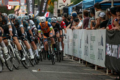 Competitors line up to take a corner in a criterium race in the United States.