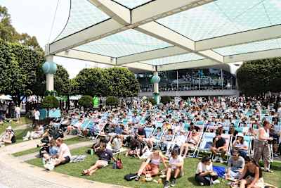 Crowds sit and watch a screen showing live matches in Garden Square during day one of the 2024 Australian Open at Melbourne Park on January 14, 2024 in Melbourne, Australia.