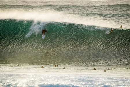 Surfer Leo Fioravanti takes off on a big wave at Pipeline in Hawaii.