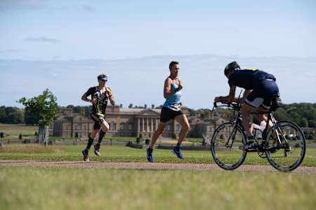 Participants race against the backdrop of the 18th century Holkham Hall