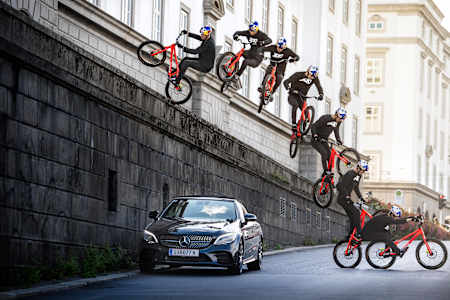 Fabio Wibmer drops in on his trial bike from a wall.