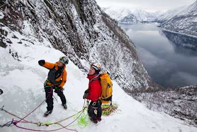 Will Gadd and Andreas Spak discuss a climbing plan at Eidfjord in Norway.