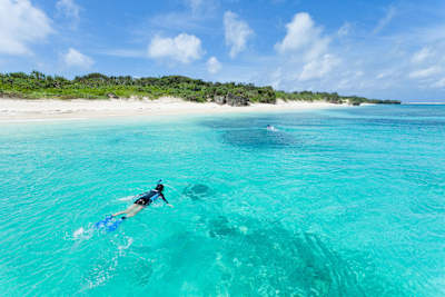 A woman snorkels off the Okinawa islands