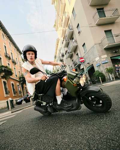  Lucas Pinheiro Braathen riding a moped.