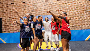A group of players standing with their arms around each other at Red Bull Four 2 Score.
