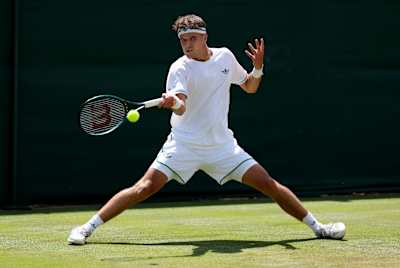 Jakub Menšík plays a forehand against Marcos Giron during the Gentlemen's Singles second round match at the Wimbledon Championships 2025. 