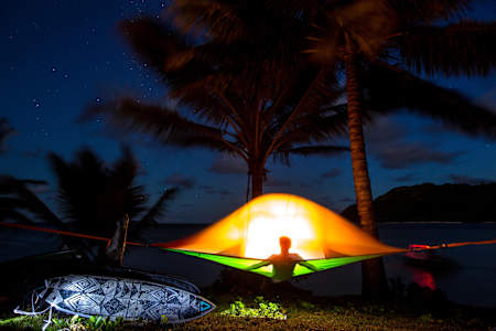 A surfer camps during an expedition.