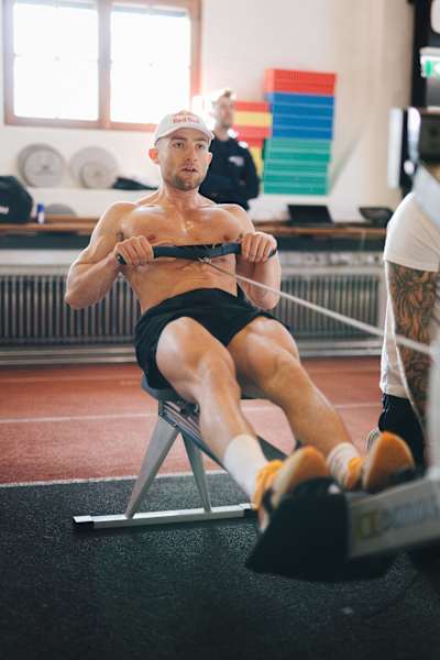 Jake Dearden trains intensely on a rowing machine.
