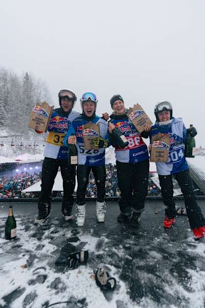 Victorious competitors hold their trophies aloft after winning the Red Bull Homerun 2026 in Åre, Sweden, surrounded by snow, excitement, and cheering crowds