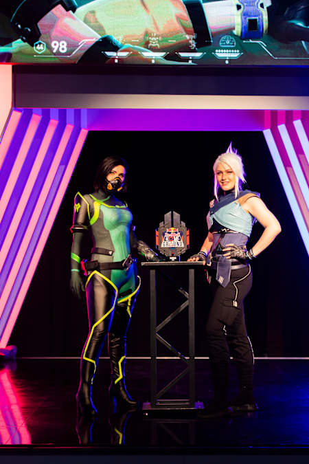Two cosplayers dressed as VALORANT Agents pose at the Red Bull Home Ground National Finals event in Amsterdam.