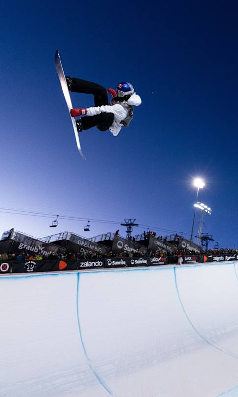 Scotty James launches above the halfpipe during the Laax Open in Laax, Switzerland, on 18 January 2025, beneath the floodlights and cheering crowd