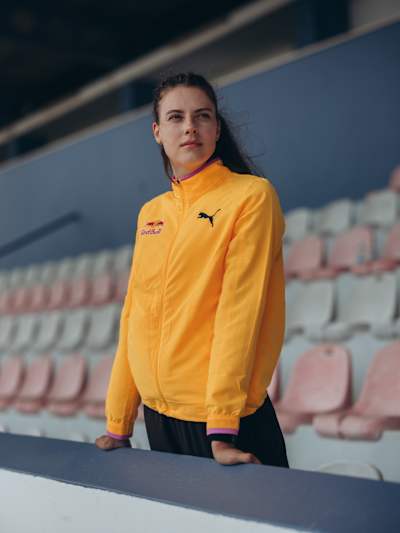 Yaroslava Mahuchikh sports a vibrant Red Bull jacket at Monte Gordo stadium in Portugal, captured on June 9, 2025, radiating athletic energy and style for the 2025 season.