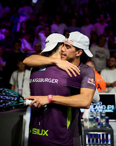 Leandro Augsburger embraces Juan Lebrón after their Premier Padel P1 Milano semi-final in Milano, Italy, on 17 October 2026, with Red Bull branding visible
