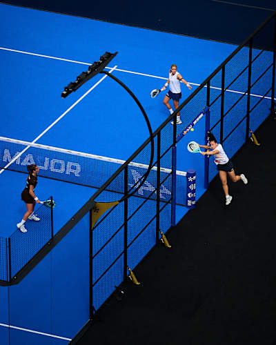 Andrea Ustero Prieto competes in the 2026 Premier Padel Major Paris semi-finals, striking a forehand on the vibrant blue padel court in Paris, France.