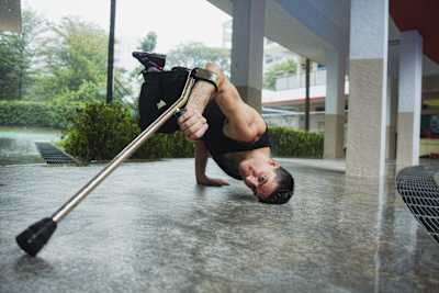 An action photo of B-Boy Lazylegz doing a freeze.