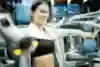 A woman using a shoulder press in the gym